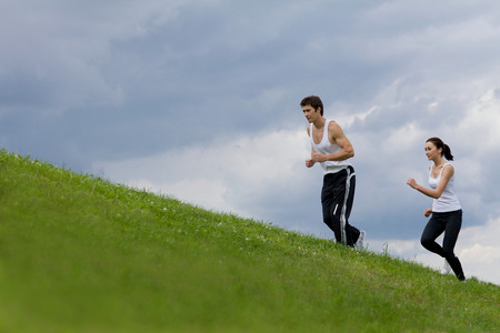 Young couple exercising in parkの写真素材