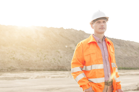 Thoughtful male supervisor looking away at construction site
