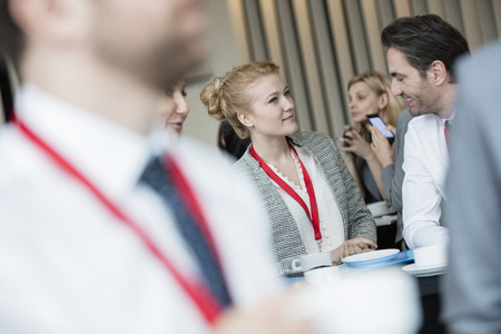 Business people talking at lobby in convention centerの写真素材