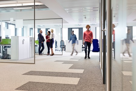 Businessmen and businesswomen in office corridor