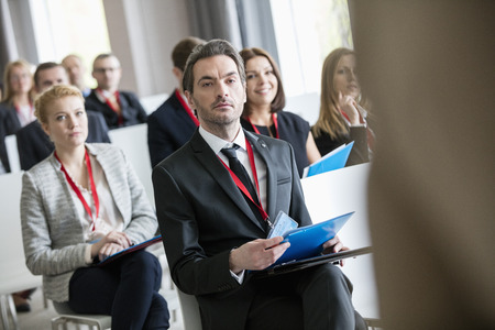 Business people attending seminar at convention centerの写真素材