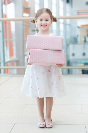Young girl holding two gift wrapped boxesの写真素材