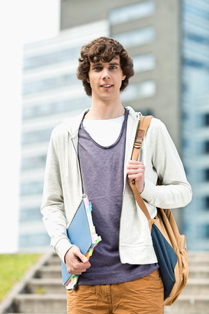 Portrait of young man standing at college campusの写真素材