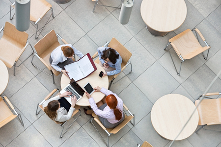 High angle view of businesswomen working in office canteenの写真素材