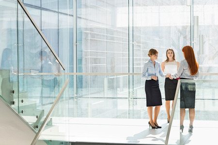 Full-length of businesswomen shaking hands in officeの写真素材