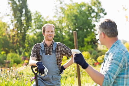 Happy gardeners talking at plant nurseryの写真素材