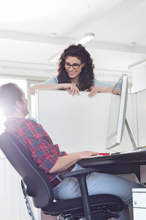 Business people talking over cubicle wallの写真素材