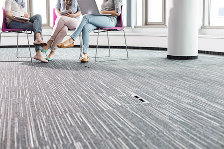 Low section of businesswomen working in creative officeの写真素材