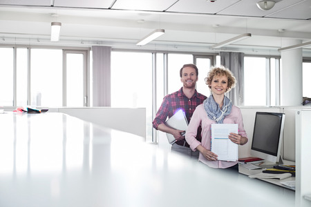 Portrait of confident business people standing in officeの写真素材