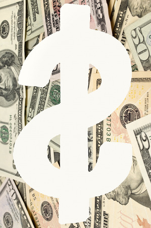 Digital composite image of dollar sign over banknotesの写真素材