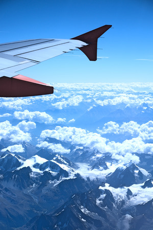 View from the plane over snowy mountainsの写真素材