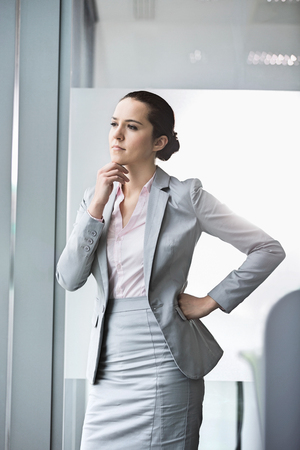 Thoughtful young businesswoman in officeの写真素材