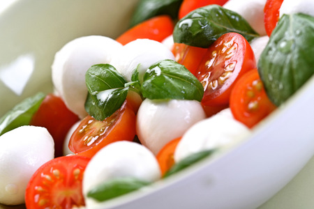 Close of tomato and mozarella in dishの写真素材