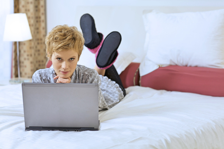 Woman at Home with Laptop Computerの写真素材