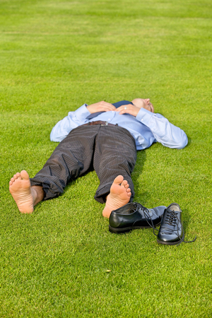 Businessman relaxing in parkの写真素材