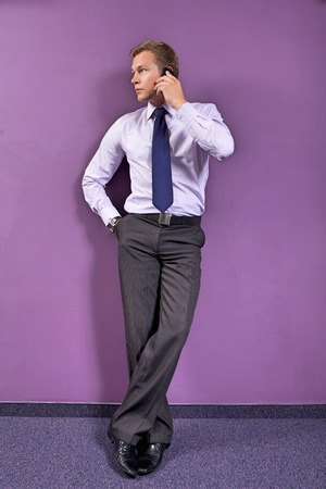 Businessman using mobile phone at officeの写真素材