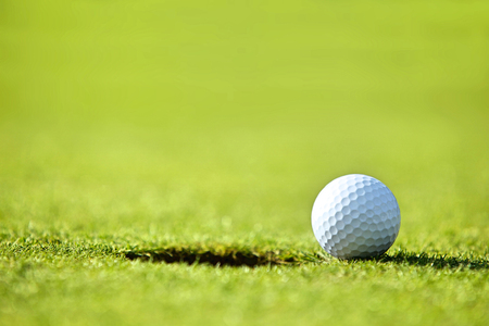 Golf ball near holeの写真素材