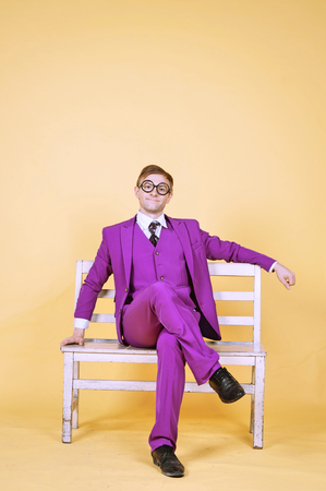 Man in Purple suit sitting on park benchの写真素材