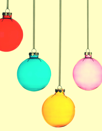 Four Christmas baubles on yellow vintage backgroundの写真素材