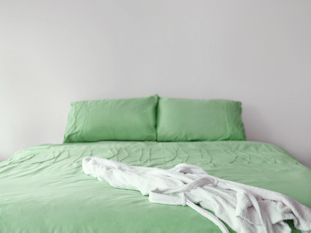Green bedding with robeの写真素材