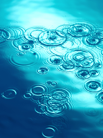 Rain falling on water pool lakeの写真素材