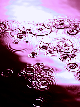 Purple Ripples on water surfaceの写真素材
