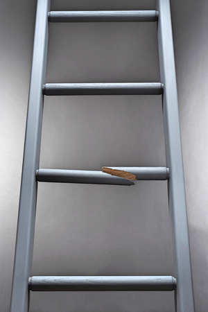Ladder with one step brokenの写真素材