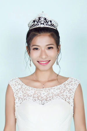Beautiful Chinese Bride against blue backgroundの写真素材