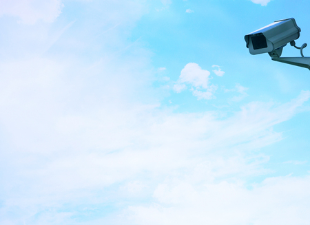 Security camera on wall against cloudsの写真素材