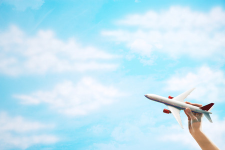 Toy Plane flying against cloudsの写真素材