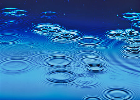 Rain falling on waterの写真素材
