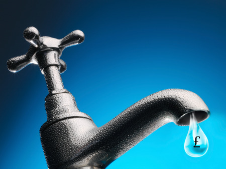 Drop of water trickling from tap close-upの写真素材
