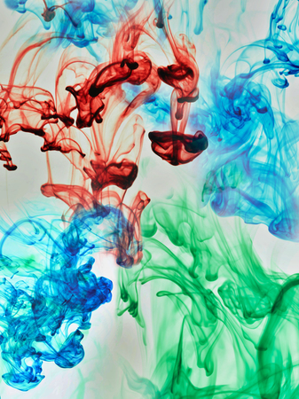 Multi-coloured substances dissolving in waterの写真素材