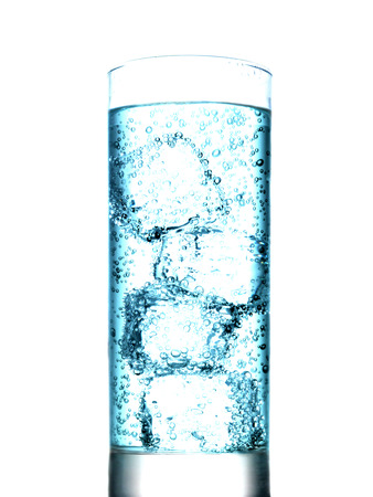 Glass of water with ice cubes on white backgroundの写真素材
