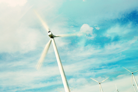 Wind Turbine against sky with clouds and sunの写真素材