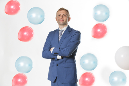 Businessman standing by falling  balloonsの写真素材