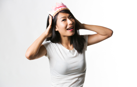 Chinese woman having fun with a princess crownの写真素材