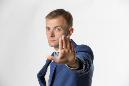 Businessman holding hand up and saying Stopの写真素材