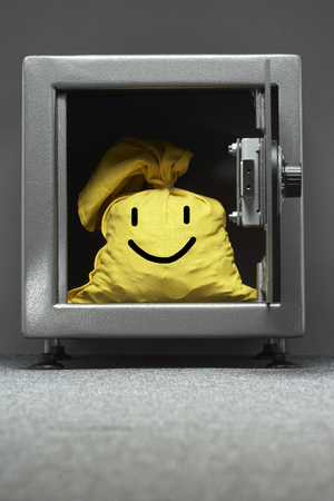 Safe with yellow sack with happy face on itの写真素材