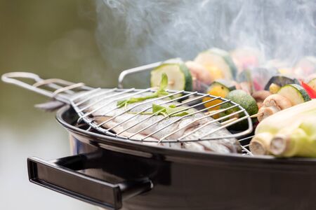 Close-up of food on barbecue grill at parkの写真素材