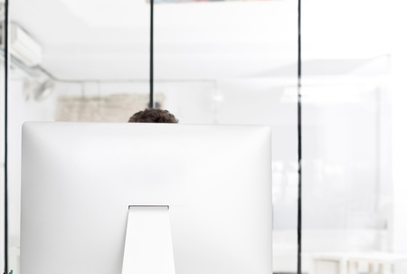 Businessman using computer against glass wallの写真素材