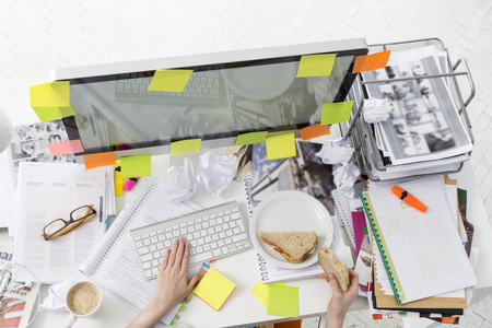 Cropped image of businessman having breakfast while working on computerの写真素材