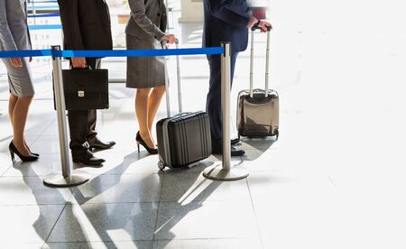 Business people queueing for check in airportの写真素材