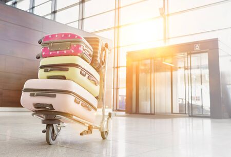 Photo of baggage on cart with lens flareの写真素材
