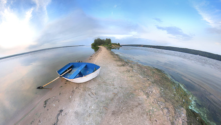 Blue rowing Boat on coastline in Volga River. Travel Landscape of Summer Vacation on Nature.の写真素材