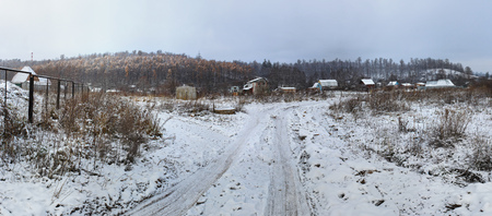 Winter Landscape with rural road and mountains with larch forest. Russian Winter.の写真素材