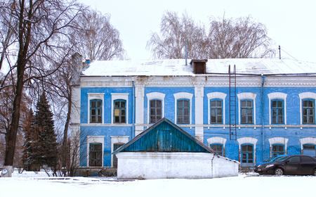 Winter Landscape with Blue House under snowの写真素材