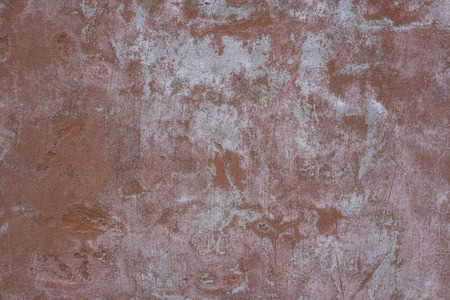 Red concrete wall. Small cracks on the surfaceの写真素材