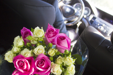 Groom rides for the uncountable with a huge bouquet of beautiful rosesの写真素材