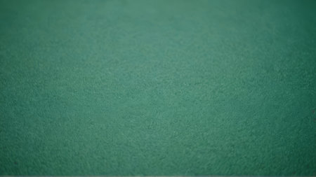 Green table football background. Close-up of a green table football table football
